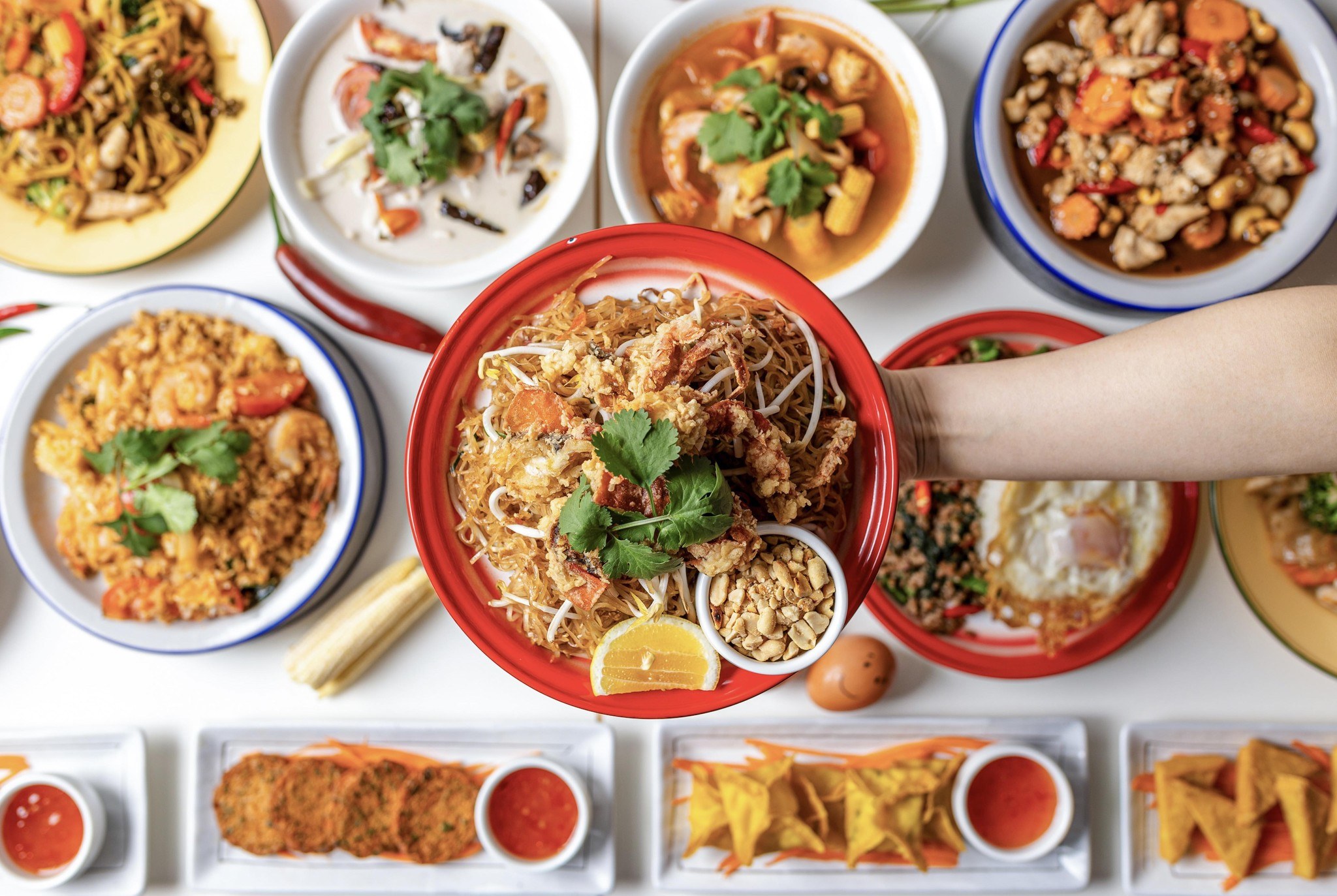 Tom Yum among a full Thai table spread at Rim Thang Thai, Glenelg